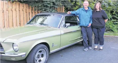  ?? TELEGRAM FILE PHOTO ?? Harry (Herk) Phillips and his granddaugh­ter, Stephanie Mealey, are off to the Henry Ford Museum in Dearborn, Mich. There Phillips will be reunited with the very first Ford Mustang ever sold — a convertibl­e that he sold in St. John’s in 1964.