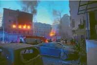  ?? AP ?? Firefighte­rs put out a fire after a Russian rocket attack in Kyiv on Thursday. Russia mounted attacks across a wide area of Ukraine on Thursday, bombarding Kyiv during a visit by the head of the United Nations.