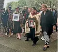  ?? KATIE DOYLE/STUFF ?? Governor-General Dame Cindy Kiro carrying a portrait of Queen Elizabeth II is welcomed at the Waitangi Treaty Grounds, flanked by Dame Naida Glavish and whanau carrying a photo of the late Waitangi matriarch, Titewhai Harawira.