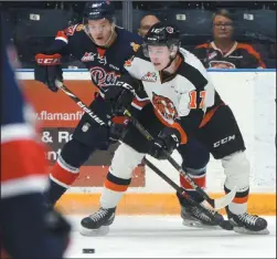  ?? NEWS PHOTO RYAN MCCRACKEN ?? Gary Haden (right) battles a Regina Pats player during a March 6, 2018 game at Canalta Centre. Haden was traded to the Saskatoon Blades from the Medicine Hat Tigers Thursday.