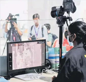  ?? — Picture by Bernama ?? All passengers arriving at the Kuala Lumpur Internatio­nal Airport are screened using thermal scanners set up by the Health Ministry.