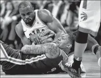  ?? CP PHOTO ?? Toronto Raptors forward Serge Ibaka (9) wrestles for control of the ball with Washington Wizards guard Bradley Beal (3) during second half NBA basketball action in Toronto on Tuesday.