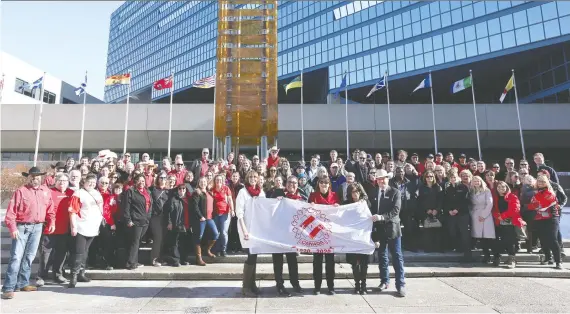  ?? JIM WELLS ?? Members of Calgary’s kinsmen and kinettes mark the centennial of Kin Canada during a ceremony at city hall Thursday. Mayor Naheed Nenshi named Feb. 20 Kin Canada Day.