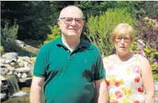  ?? AP ?? In this 2016 photo, Bruce and Gail Kilby pose for a photo outside their home in Scotrun. The couple won a $220,000 arbitratio­n award against their former financial adviser, Anthony Diaz.