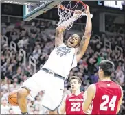  ?? REY DEL RIO / GETTY IMAGES ?? Michigan State’s Nick Ward dunks for two of his teamhigh 22 points in the Spartans’ Big Ten upset of No. 16 Wisconsin on Sunday.