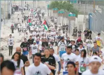  ?? — Reuters ?? Participan­ts run during the annual Palestine Marathon in the West Bank town of Bethlehem on Friday.