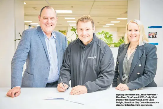  ?? ?? Signing a contract are Lance Vervoort — Hamilton City Council CEO, Craig West Downer NZ country lead, Eeva-Liisa Wright, Hamilton City Council executive director infrastruc­ture operations.