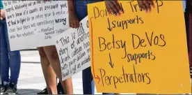  ?? AP ?? People protest proposed changes to Title IX before a speech by Education Secretary Betsy DeVos at George Mason University’s Arlington, Va., campus.