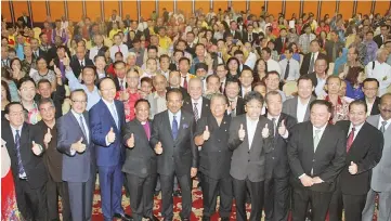  ??  ?? Front row, Chief Minister Tan Sri Musa Aman (sixth from left), Deputy Chief Ministers Tan Sri Joseph Pairin Kitingan (seventh left), Datuk Seri Panglima Raymond Tan (fourth right), Teo (fourth left), other ministers and leaders with the representa­tives...