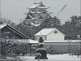  ?? PHOTOS: KYODO NEWS VIA AP ?? Nagoya castle is covered with snow on a winter day in Nagoya, Aichi prefecture, central Japan, on Saturday.