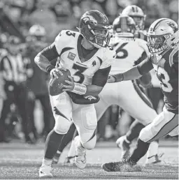  ?? RUSTY JONES/AP ?? Broncos quarterbac­k Russell Wilson scrambles from Panthers defensive end Brian Burns on Sunday in Charlotte, N.C.