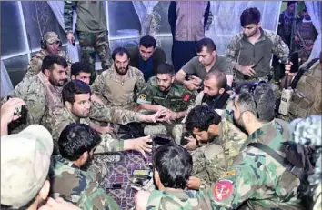 ?? Sami Sadat via The New York Times ?? Akmal Amir and soldiers with the 215 Maiwand Corps in Helmand after a night operation in August 2021.