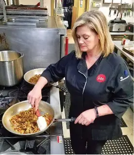  ?? Staff photo by Aaron Brand ?? ■ Jennifer Tanner, executive chef at Julie’s Deli, prepares a chicken tetrazzini sauce. Tanner will prepare dishes for a Crafted Beer &amp; Local Food Pairing event taking place from 7 p.m. to 9 p.m. Thursday at the deli.