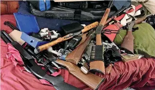  ?? [PHOTOS PROVIDED] ?? Tulsa County deputies pile up items seized on Thursday from a residence in the 2700 block of East Admiral Court, where Tulsa police found a grenade earlier in the year.