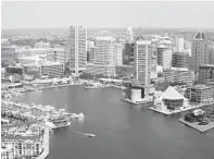  ?? LLOYD FOX/BALTIMORE SUN ?? Aerial of the Inner Harbor where new apartment buildings have opened even as the city’s overall population has fallen.