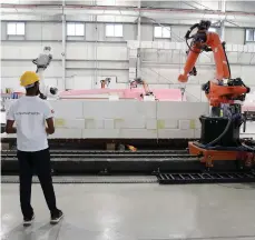  ?? Pawan Singh / The National ?? Robots prepare moulding for a yacht at the Sunreef shipyard in RAK Maritime City Free Zone