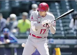  ?? Ted S. Warren Associated Press ?? THE ANGELS’ Shohei Ohtani is hit by a pitch on his right elbow in the first inning. Ohtani stayed in the game and later said his elbow was “feeling better.”