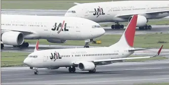  ?? PHOTO: REUTERS ?? A Japan Airlines aircraft on the tarmac at Haneda airport in Tokyo. The carrier listed on the Tokyo Stock Exchange yesterday in an $8.5bn IPO three years after entering bankruptcy protection. The shares rose a modest 1 percent on the day.