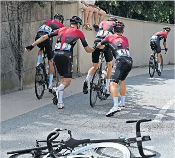  ??  ?? Recovery mode: Geraint Thomas and his Ineos team-mates scramble to get back in the race after disaster struck outside Saint-Etienne
