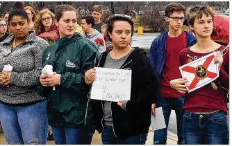  ?? WILL GARBE / STAFF ?? Students at the Dayton Regional STEM School walk out of school Wednesday in memory of the 17 individual­s who died during the mass shooting at Marjory Stoneman Douglas High School in Parkland, Fla. Miami Valley School and Tippecanoe High School also...