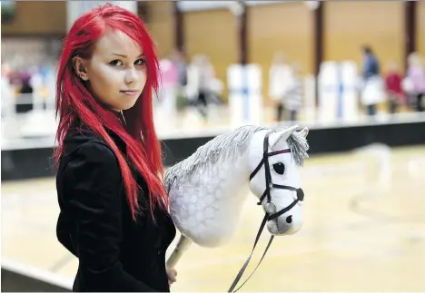  ?? PHOTOS: HEIKKI SAUKKOMAA/LEHTIKUVA/THE ASSOCIATED PRESS ?? Alisa Aarniomaki, 20, holds her hobby-horse during the activity’s Finnish championsh­ips. Thousands of young people in Finland have taken up hobbyhorsi­ng, which has a strong therapeuti­c element and social media subculture.