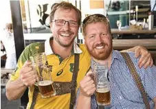  ??  ?? German beer enthusiast­s Henry Hubbard and William Krisanki sample a couple of steins at The Bavarian.