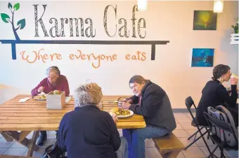  ?? MARLA BROSE/JOURNAL ?? Restaurant reviewer T.M. Collins says to let karma do its work without the public shaming of political figures at eateries. Above is Albuquerqu­e’s Karma Cafe, “where everyone eats.”