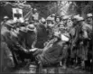  ?? COURTESY OF THE LIBRARY OF CONGRESS ?? American troops helping wounded German soldiers in a forested area at Meuse-Argonne, France (September 1918).