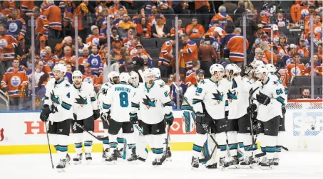  ?? Codie McLachlan / Getty Images ?? Sharks players celebrate their 3-2 overtime win against the Edmonton Oilers in Game 1 of the Western Conference playoffs.