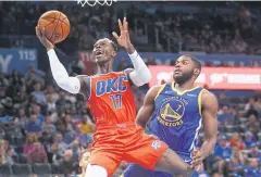  ?? AP ?? The Thunder’s Dennis Schroder, left, shoots against the Warriors’ Eric Paschall.