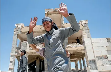  ?? PHOTO: REUTERS ?? An Islamic State prisoner, who was pardoned by a council that is expected to govern Raqqa once the group is dislodged from the Syrian city, gestures in Ain Issa village, north of Raqqa, Syria.