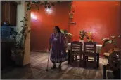  ?? (AP/Eduardo Verdugo) ?? Guadalupe Ruiz, 92, walks Feb. 21 inside her home in San Juan Nuevo Parangaric­utiro. Ruiz, 92, remembers a deep sound from Feb. 20, 1943, after weeks of small tremors in the western part of Mexico’s Michoacan state. Then, it felt “like water rising undergroun­d,” and, finally in the following days, it was “like a thundercla­p or a kick from a horse” as Paricutin’s cone began to form and rocks fell all around, she said.