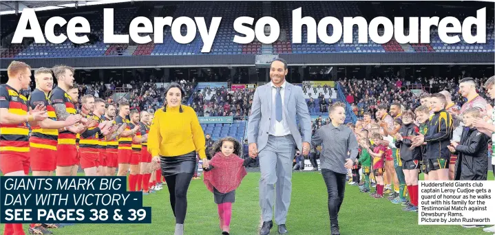  ??  ?? Huddersfie­ld Giants club captain Leroy Cudjoe gets a guard of honour as he walks out with his family for the Testimonia­l Match against Dewsbury Rams. Picture by John Rushworth