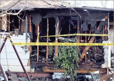  ?? Doug Walker / RN-T ?? Two middle-aged men were killed in this house fire on Martin Luther King Jr. Circle in Kingston on Friday morning. An elderly man and woman were taken to area hospitals for treatment of injuries. Six pets also died in the fire.