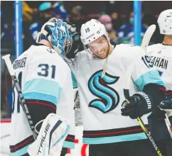  ?? BOB FRID / USA TODAY SPORTS ?? Goalie Philipp Grubauer and forward Calle Jarnkrok celebrate after the expansion Kraken beat the Canucks 4-0 in pre-season action earlier this week in Vancouver. Seattle won four of six pre-season starts and many around the NHL expect them to push for a playoff spot.