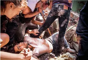  ?? AP ?? SEARCH FOR SURVIVORS: A man trapped in a crevice is being rescued from a collapsed building in the Condesa neighbourh­ood of Mexico City on Tuesday. —