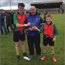  ??  ?? Christy Mooney and Keith Burke were joint captains for St Kevin’s and they were presented with the cup by Kieran O’Shea.
