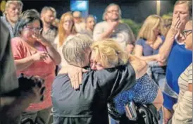  ?? AP PHOTO ?? Texas governor Greg Abbott consoles a woman at the First Baptist Church in Sutherland Springs, the site of Sunday’s fatal shooting.