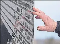  ?? THE CANADIAN PRESS/ANDREW VAUGHAN ?? A hand touches the monument that honours the 26 coal miners who perished in the Westray mine disaster at the Westray Miners Memorial Park in New Glasgow, N.S. on Tuesday. The coal mine exploded 25 years ago to the day on May 9, 1992.