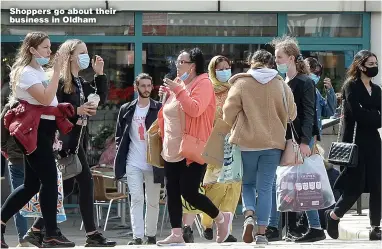  ?? Pictures: JULIAN HAMILTON, PA ?? Shoppers go about their business in Oldham