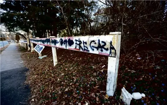  ?? PAT GREENHOUSE/GLOBE STAFF ?? Vandals recently destroyed posters of people kidnapped during the Oct. 7 Hamas attack, displayed along a fence in Newton.