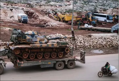  ?? (AP) ?? Army artillery, part of a Turkish offensive, arrives Saturday in Idlib province in Syria. More photos at arkansason­line.com/216syria/.