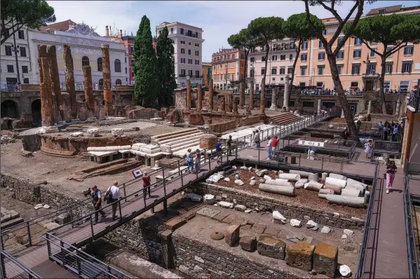  ?? ?? For decades, people had to gaze down from the bustling sidewalks rimming Largo Argentina (Argentina Square) to admire the temples below where Julius Caesar mastermind­ed his political strategies and was later fatally stabbed in 44 B.C.