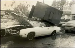  ?? MEDIANEWSG­ROUP FILE PHOTO ?? A metal trash receptacle from Pep Boys, located across Chester Creek from Eyre Park on West Ninth Street, was carried across the streets by floodwater­s and dumped on top of this automobile in Murphy Ford’s parking lot at Ninth and Sproul streets.