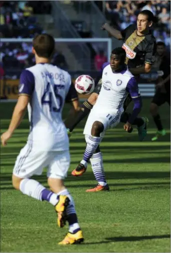  ?? MICHAEL PEREZ — THE ASSOCIATED PRESS ?? The Union’s Alejandro Bedoya, right, and Orlando City’s Carlos Rivas battle for the ball as Mikey Ambrose looks on early in Sunday’s 2-0 Orlando City victory at Talen Energy Stadium in Chester.