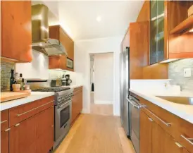  ?? Open Homes Photograph­y ?? The updated kitchen hosts custom cabinetry, stainless steel appliances and a subway tile backsplash.