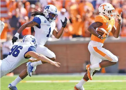  ?? STAFF PHOTO BY ROBIN RUDD ?? Tennessee’s Ty Chandler breaks into the open on the way to a 91-yard kickoff return on the first play of Saturday’s game at Neyland Stadium, a 42-7 win for the host Volunteers.