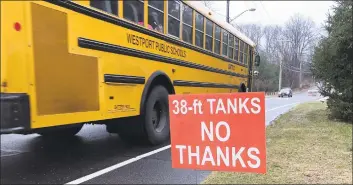  ?? Contribute­d Photo ?? A school bus passes an antiAquari­on tank sign in Westport in 2017.