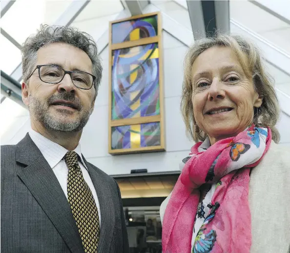  ?? LARRY WONG ?? Scott Watson and his sister Catherine Watson donated the stained-glass window seen in the background to the Grey Nuns Hospital, where it was unveiled in the front foyer of the hospital on Wednesday. The window was salvaged from the former...