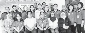 ??  ?? Mackos (seated third right) flanked by Dr Puspa (on his left) and Philip with staff of the dental unit.
